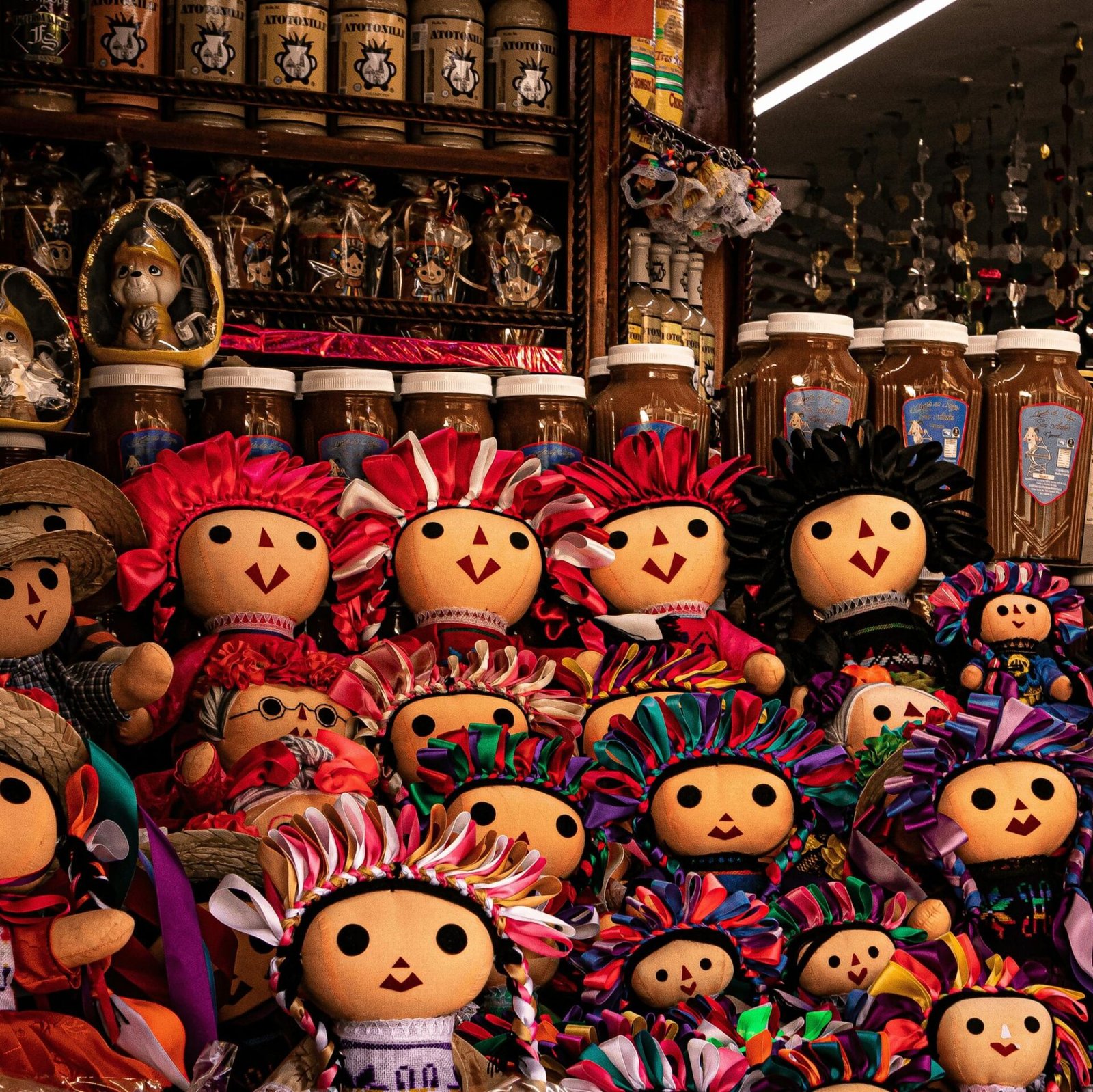 Vibrant hand-painted Mexican dolls on display in a traditional shop, showcasing local culture.
