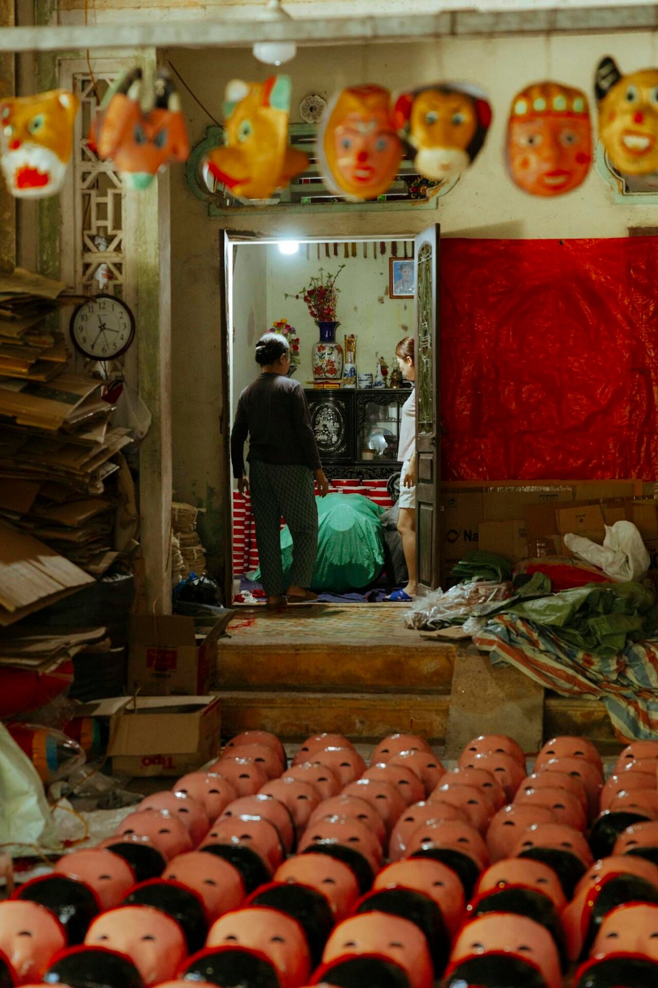 Vibrant masks displayed in an artisan's workshop, highlighting traditional craftsmanship and cultural art.